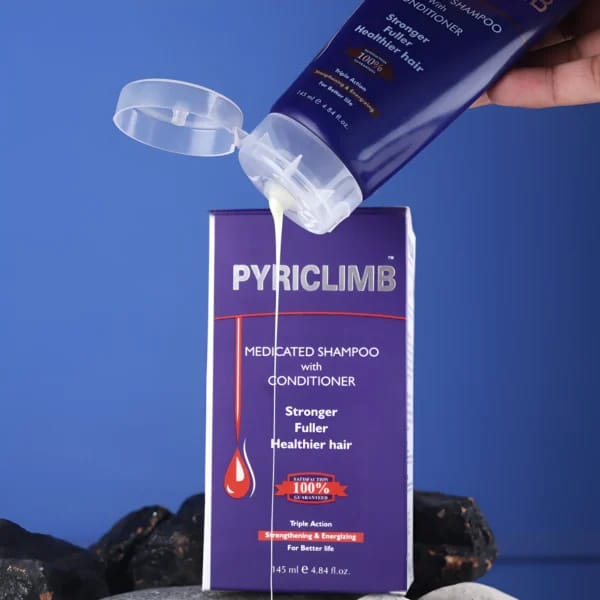 PYRICLIMB shampoo and conditioner bottle being poured onto its packaging against a blue background.